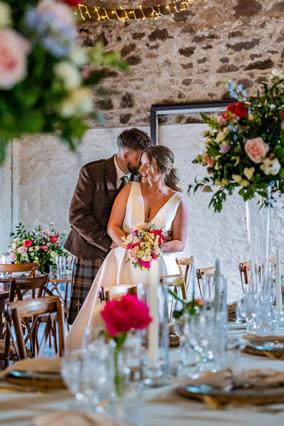 Newlyweds share a moment in Kinclune Steading before wedding breakfast